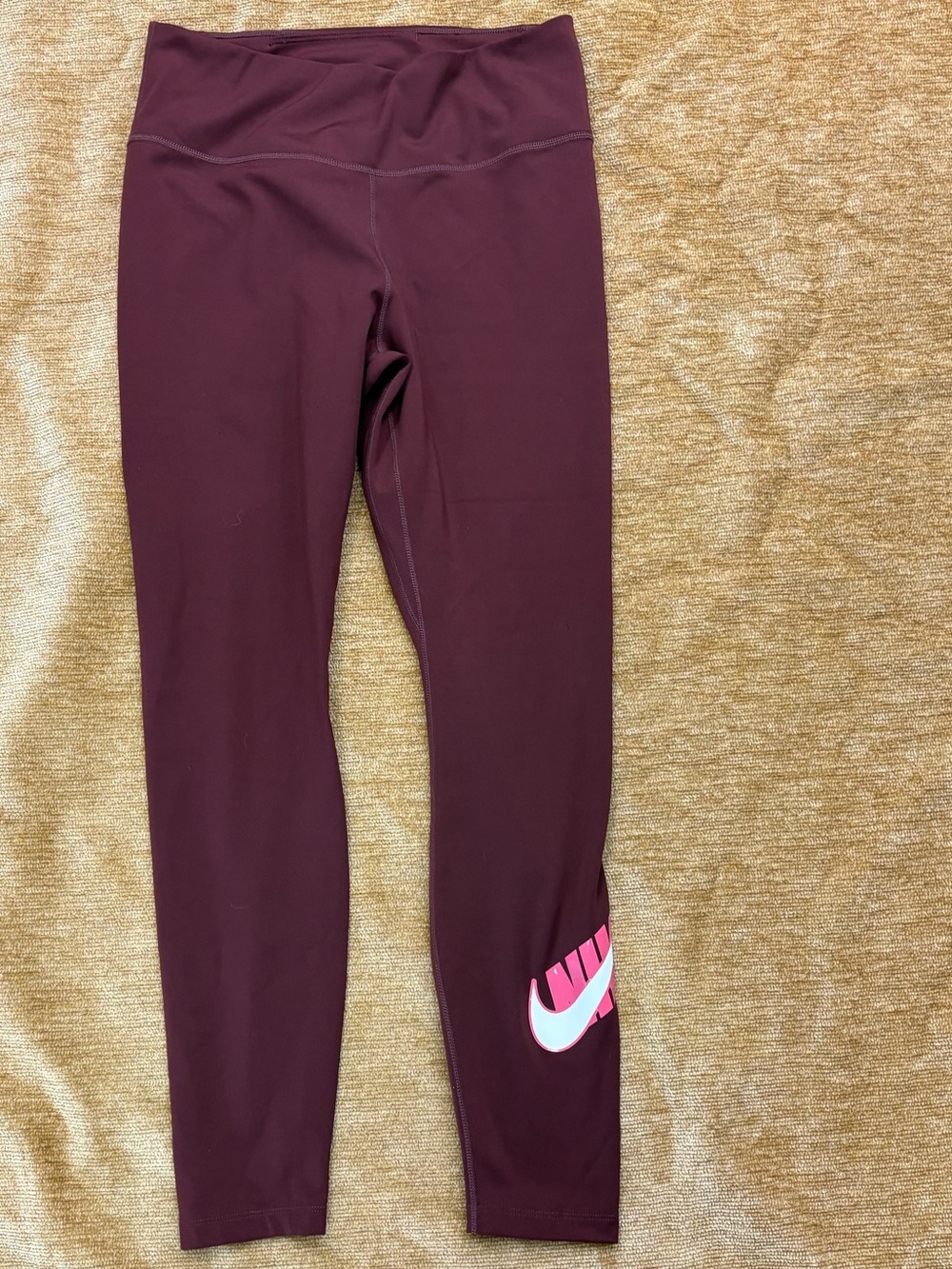 Nike Maroon Leggings with Pink and White Swoosh on left calf. Size medium